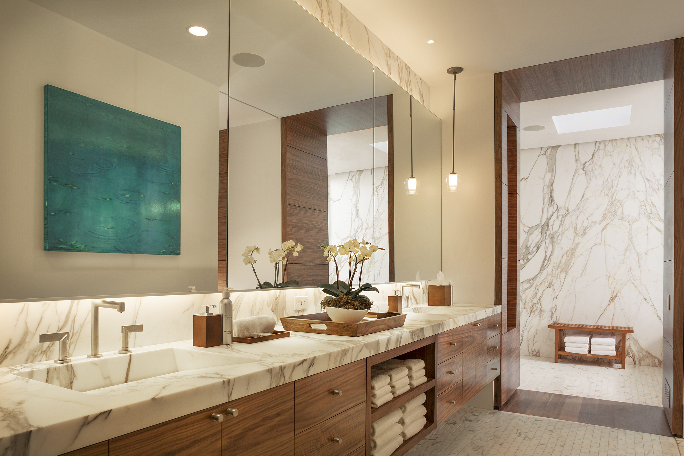 a bathroom with marble counter tops and a large mirror