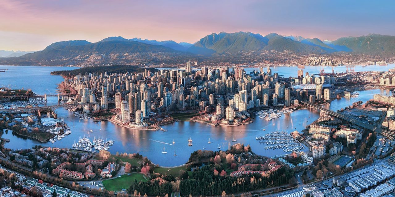 a city with many tall buildings and boats in the water