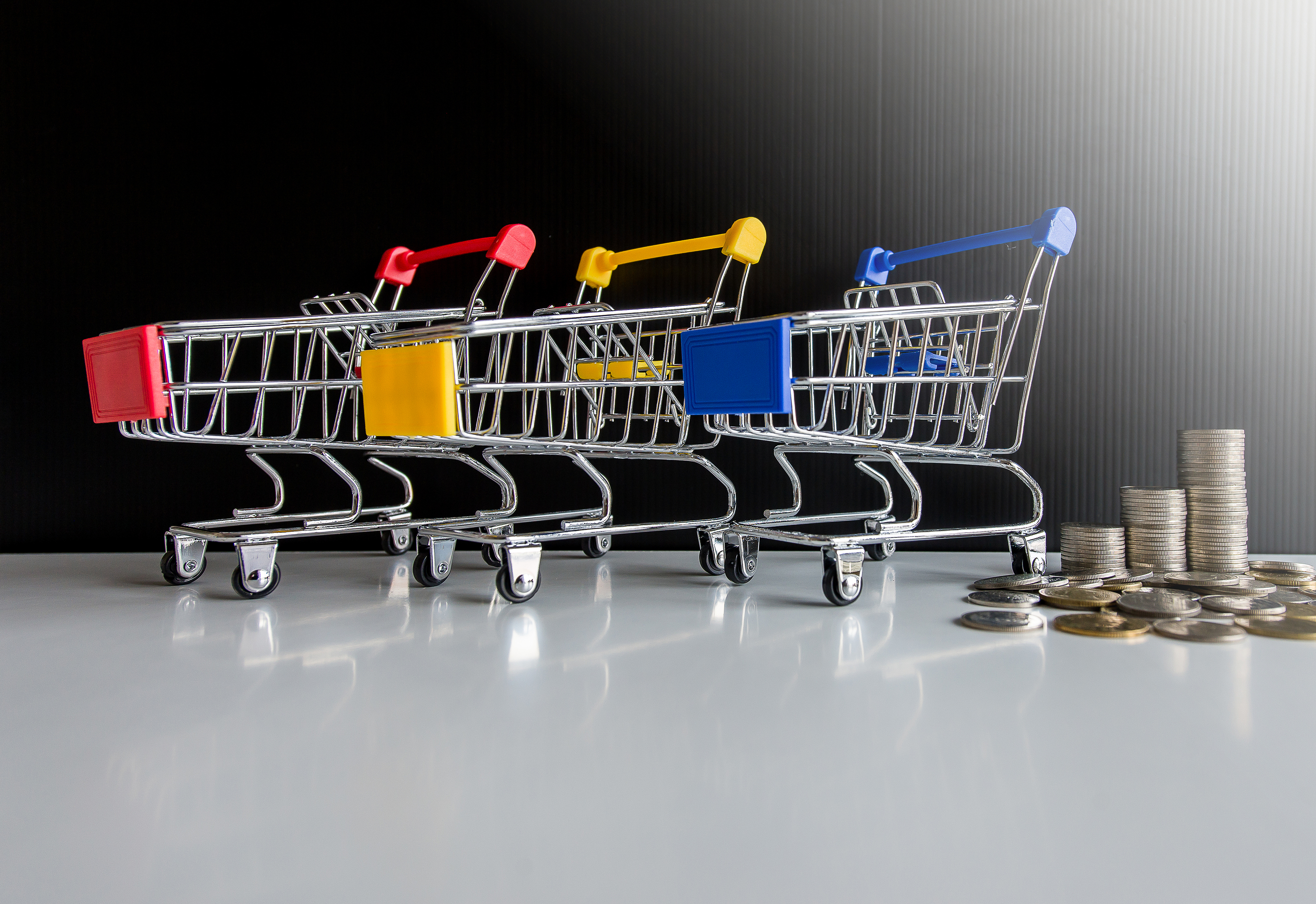 a group of shopping carts with a stack of coins