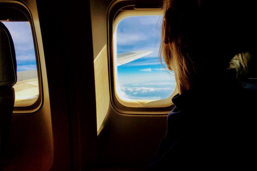 a person looking out the window of an airplane