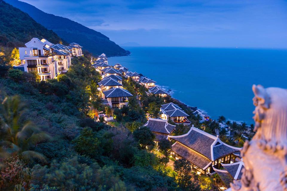 a group of houses on a hillside by the ocean