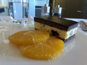 a slice of cake and orange slices on a plate