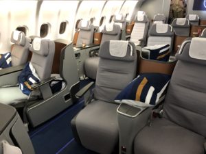 a plane with seats and a blue carpet