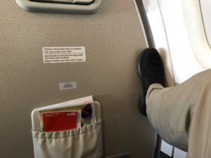 a person's foot in a pocket on an airplane
