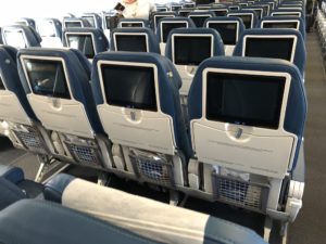 a row of seats with monitors