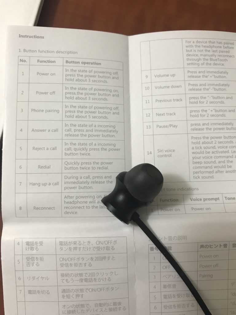 a black earbuds on a white paper