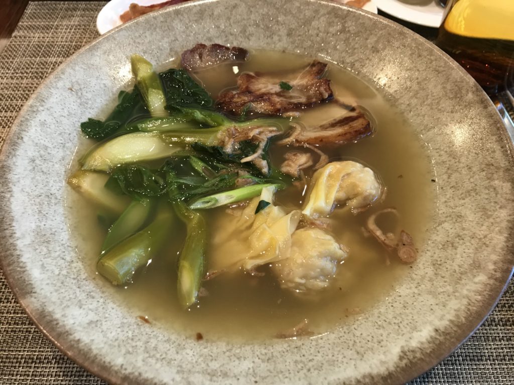a bowl of soup with meat and vegetables