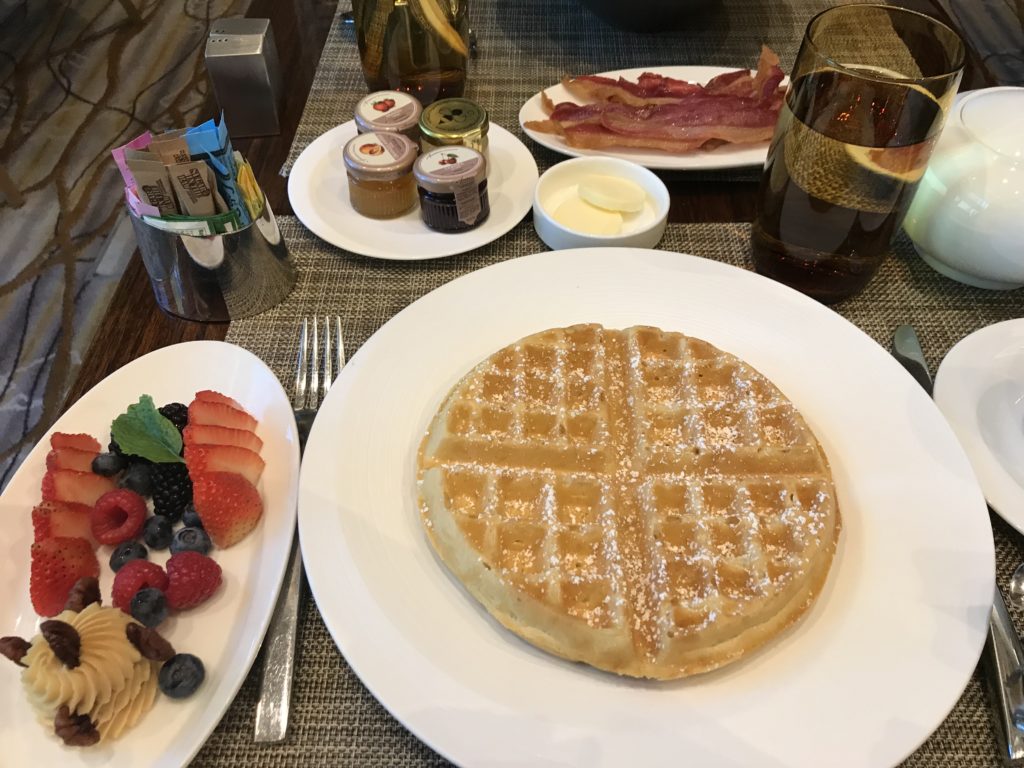 a waffle and fruit on a table