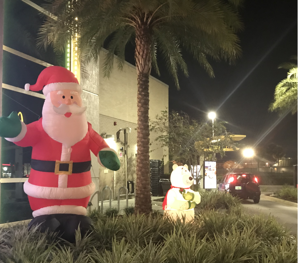 a inflatable santa claus and polar bear in the grass
