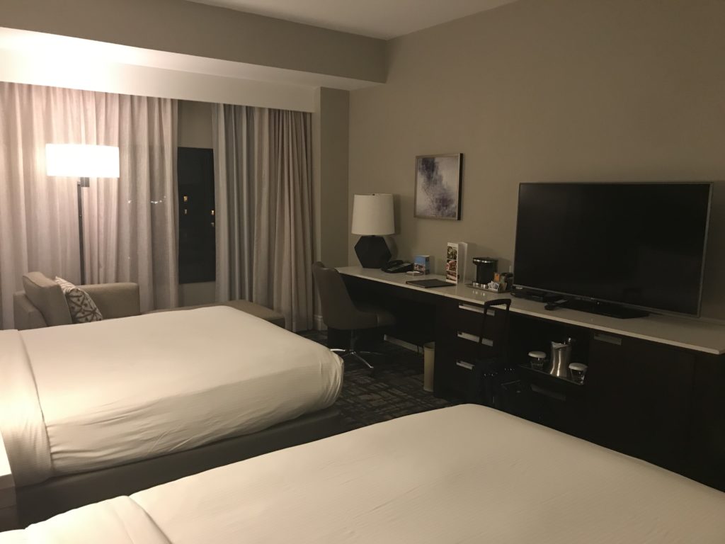 a room with two beds and a tv