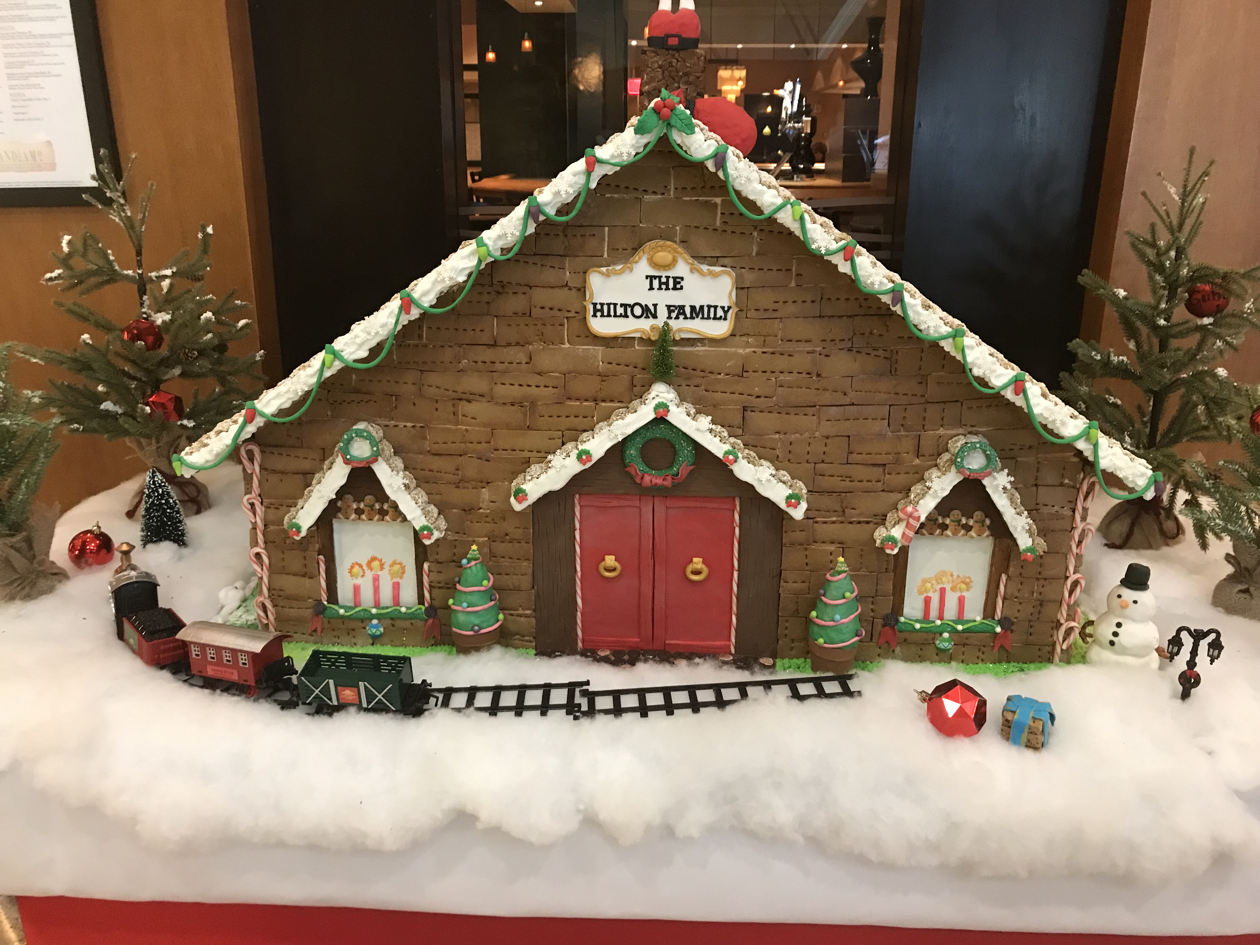 a gingerbread house with train and decorations