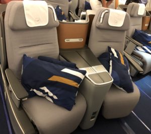 a group of seats with pillows on the side