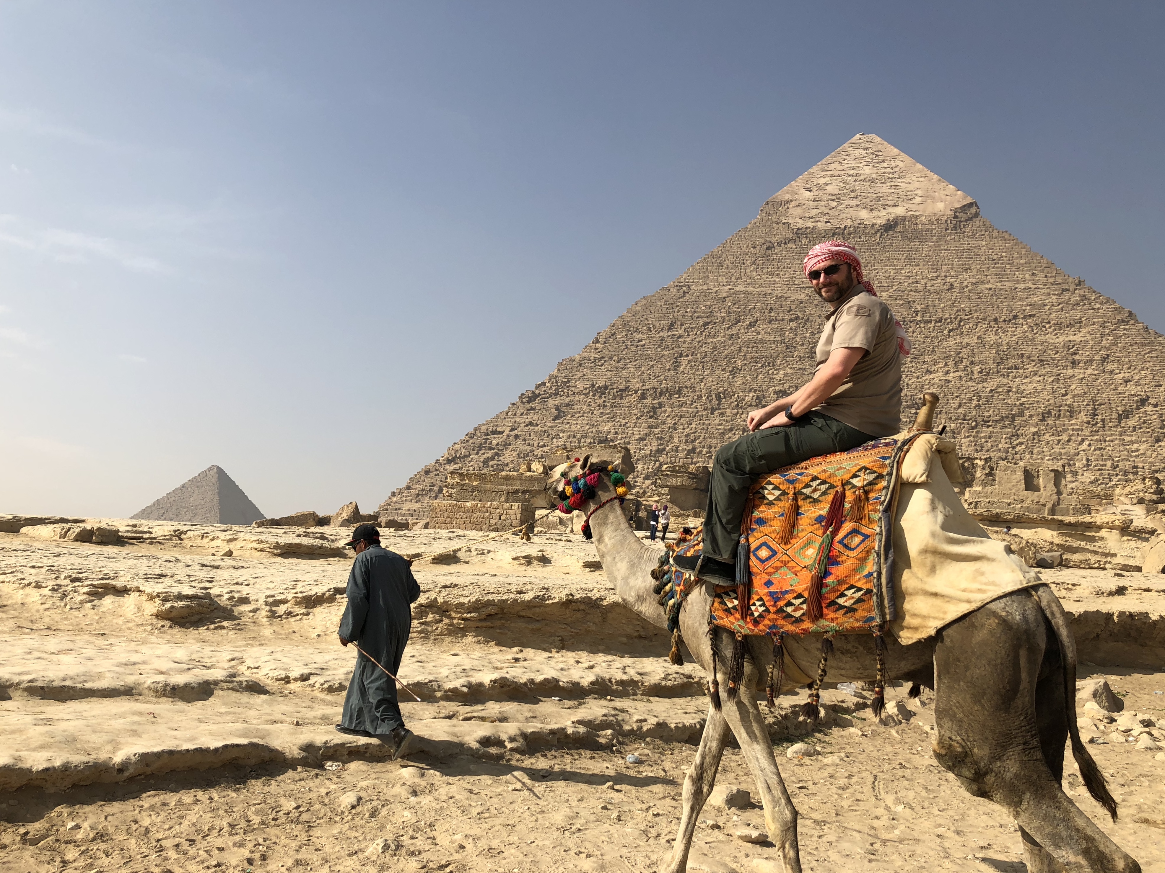 a man riding a camel in the desert