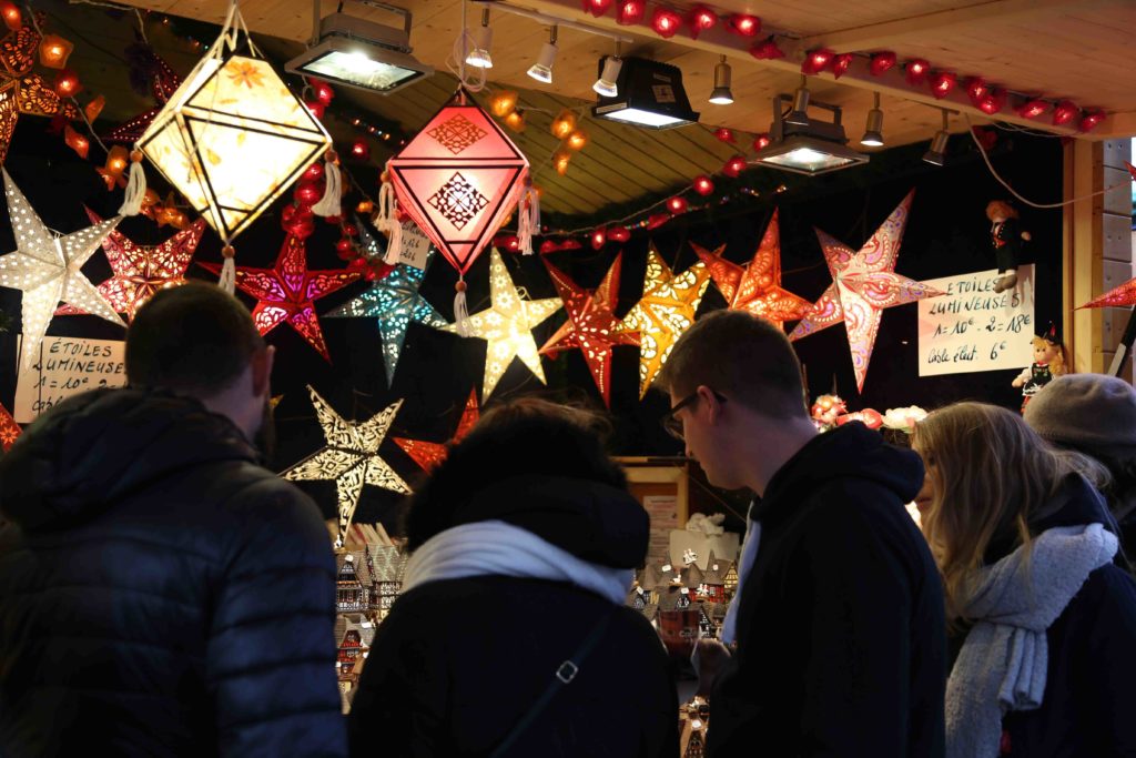 people in a market with stars and lights