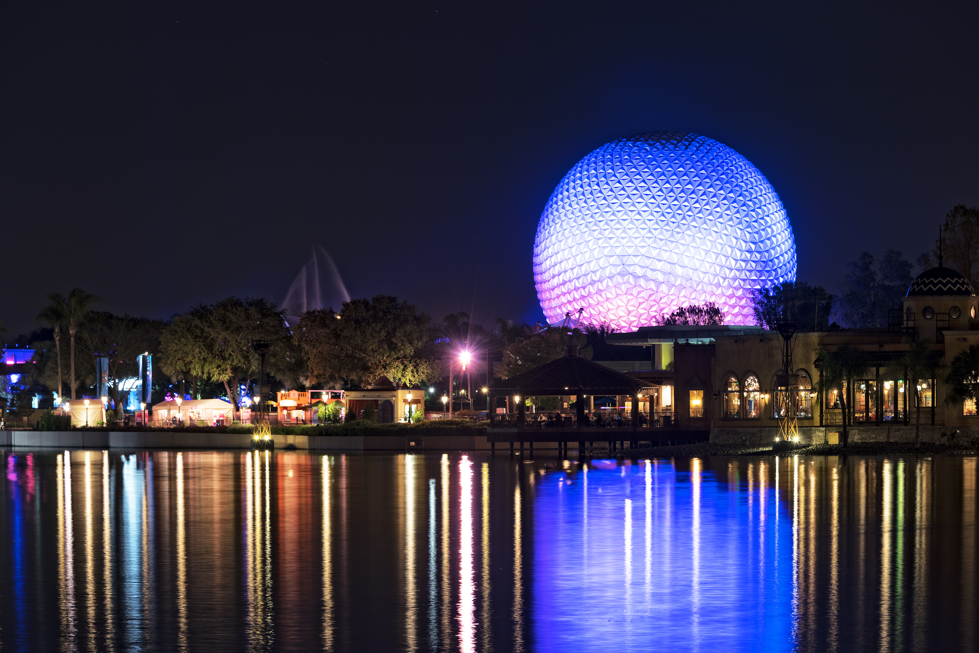 a large sphere in the middle of a lake at night