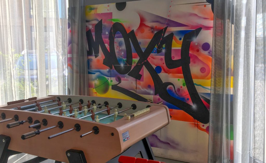 a foosball table in a room with graffiti