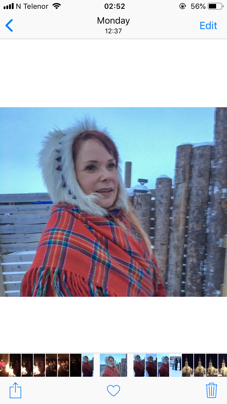 a woman wearing a red and white fur hat and scarf