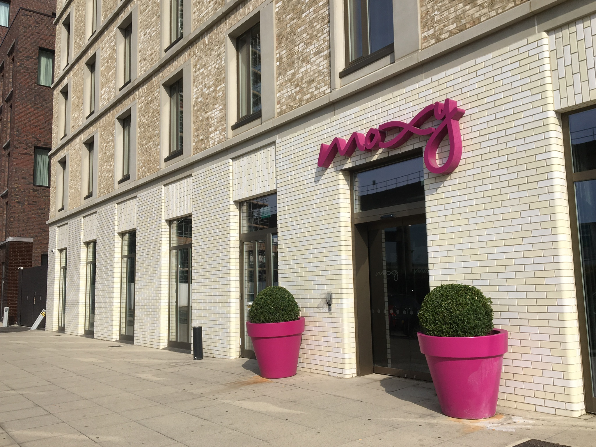 a building with pink sign