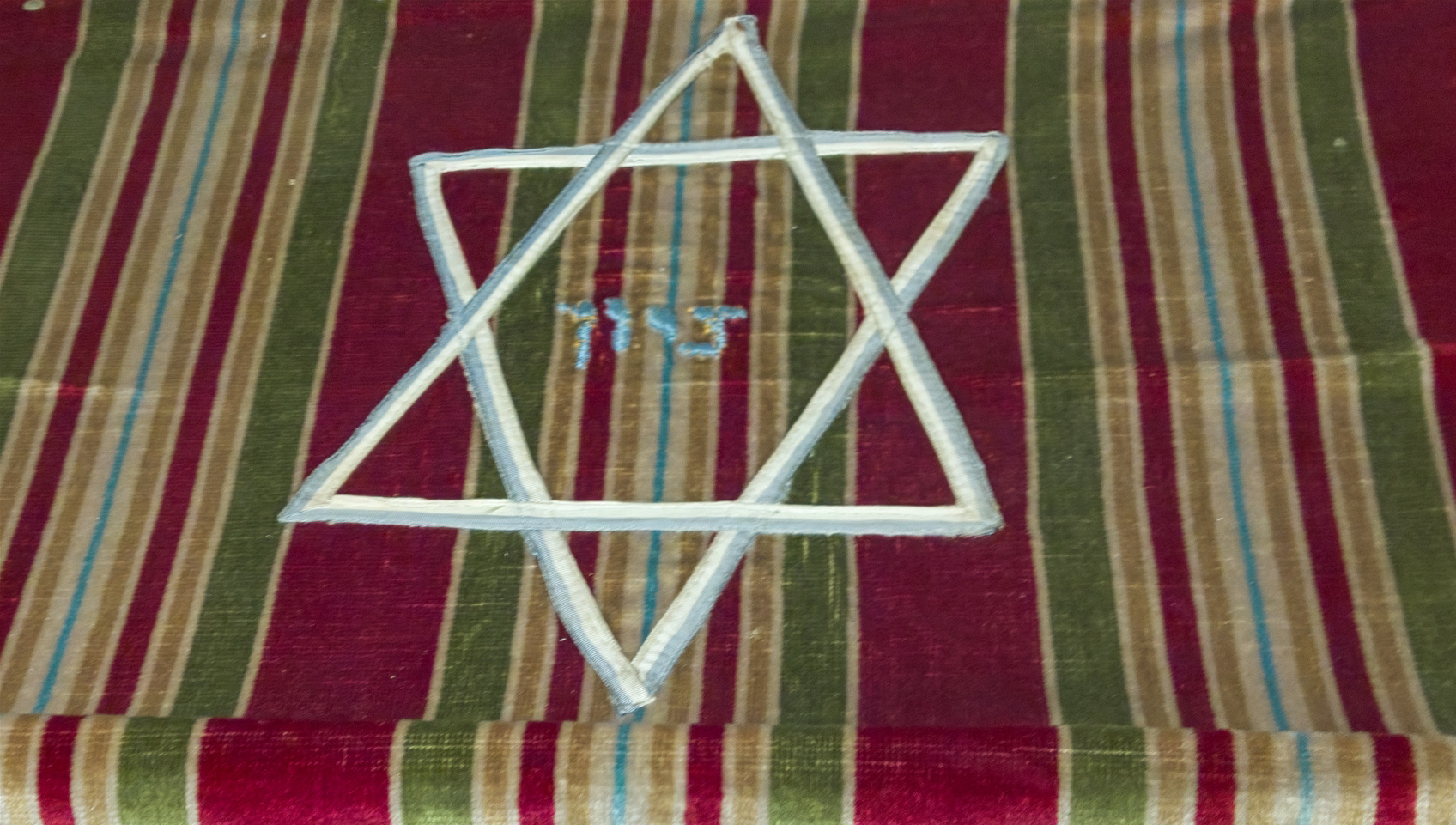 a white star on a colorful cloth