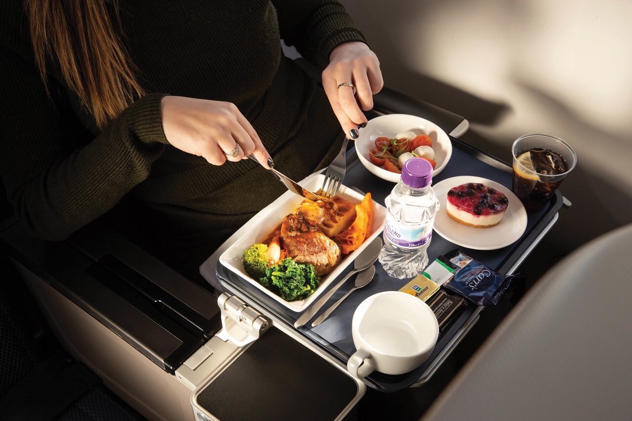 a person eating food on a tray