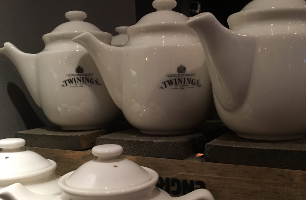 a group of teapots on a wooden shelf