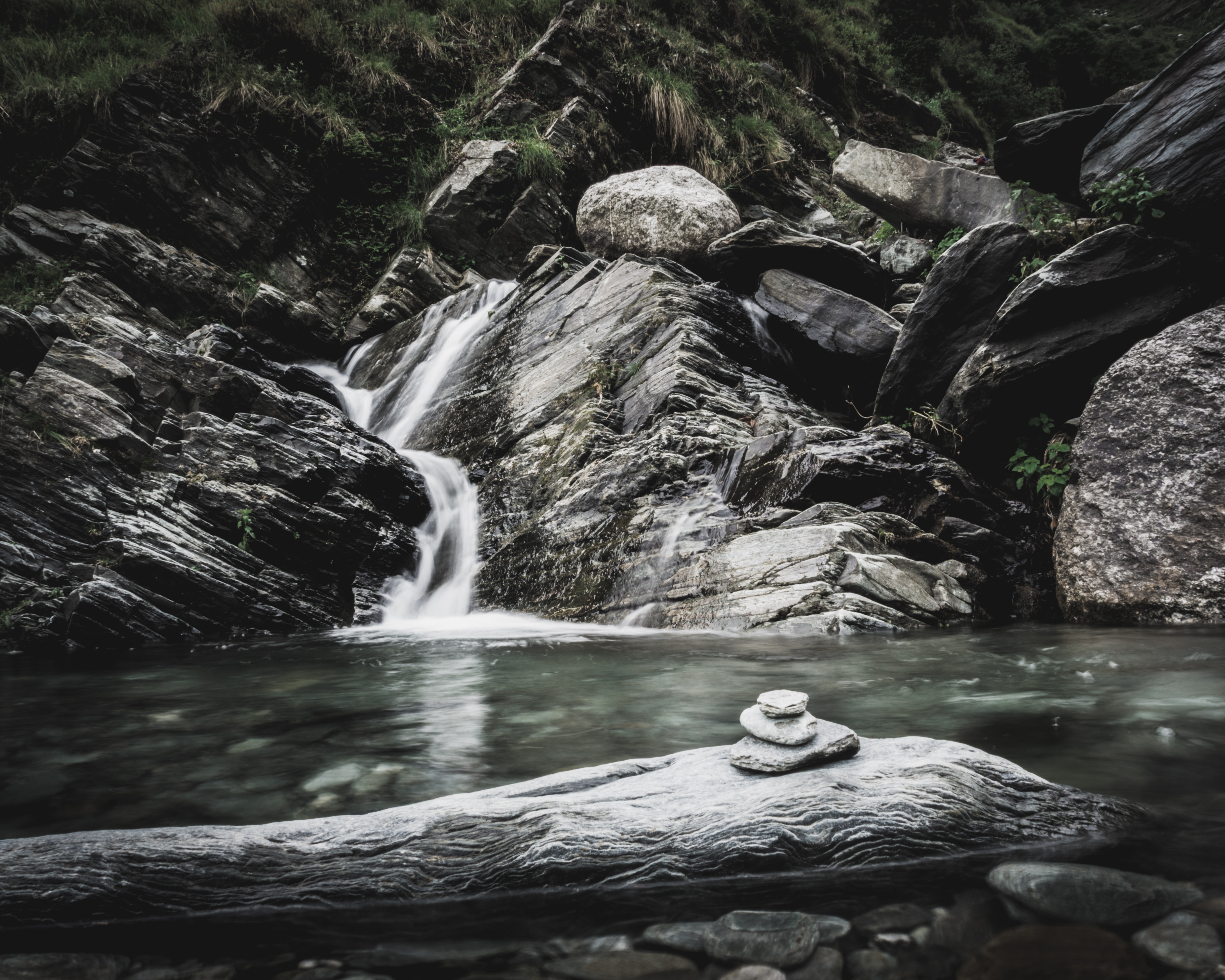 a waterfall with rocks and water