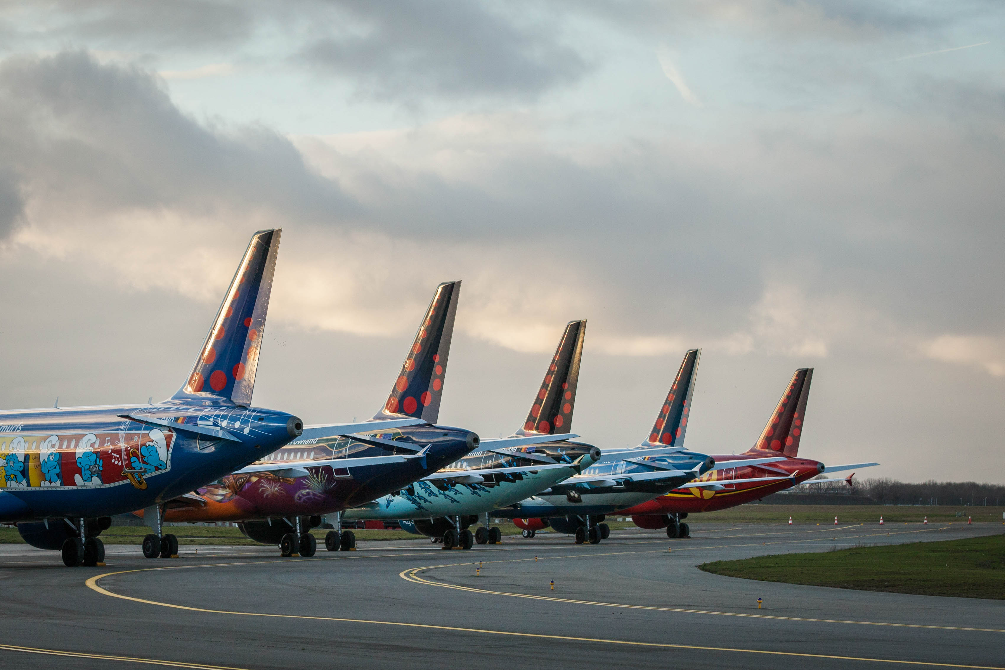 a group of airplanes parked on a runway