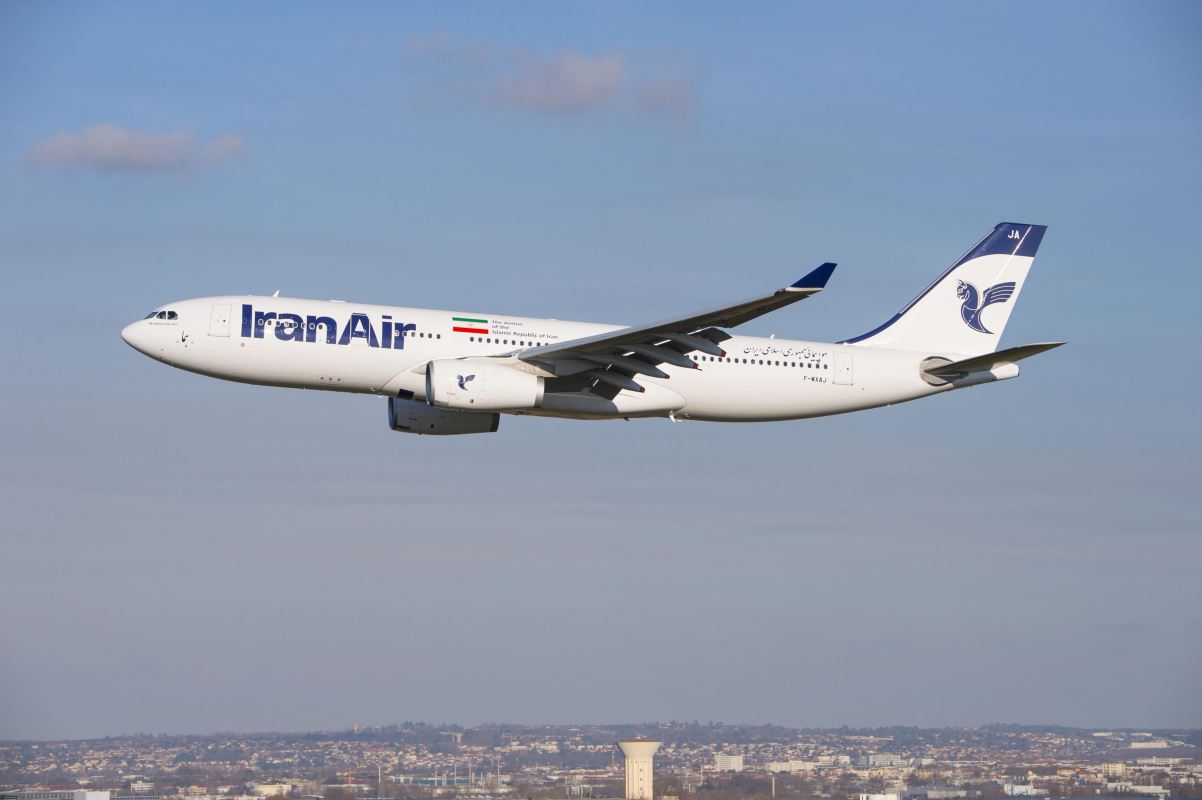 a white airplane flying in the sky