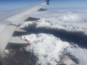 an airplane wing over mountains