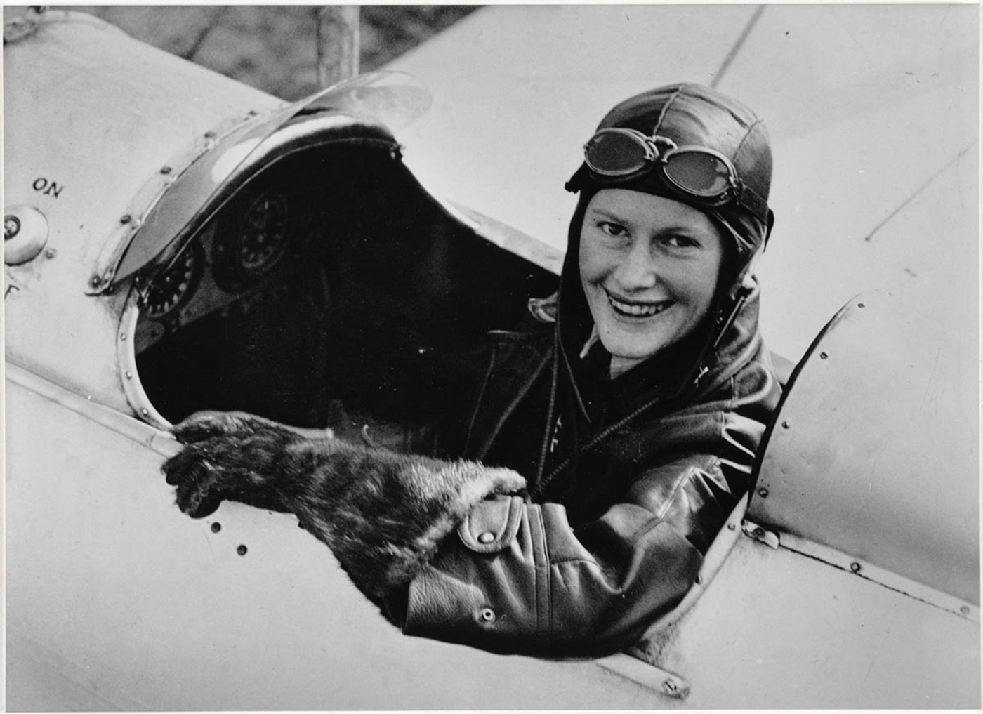 a woman in a pilot's hat and goggles