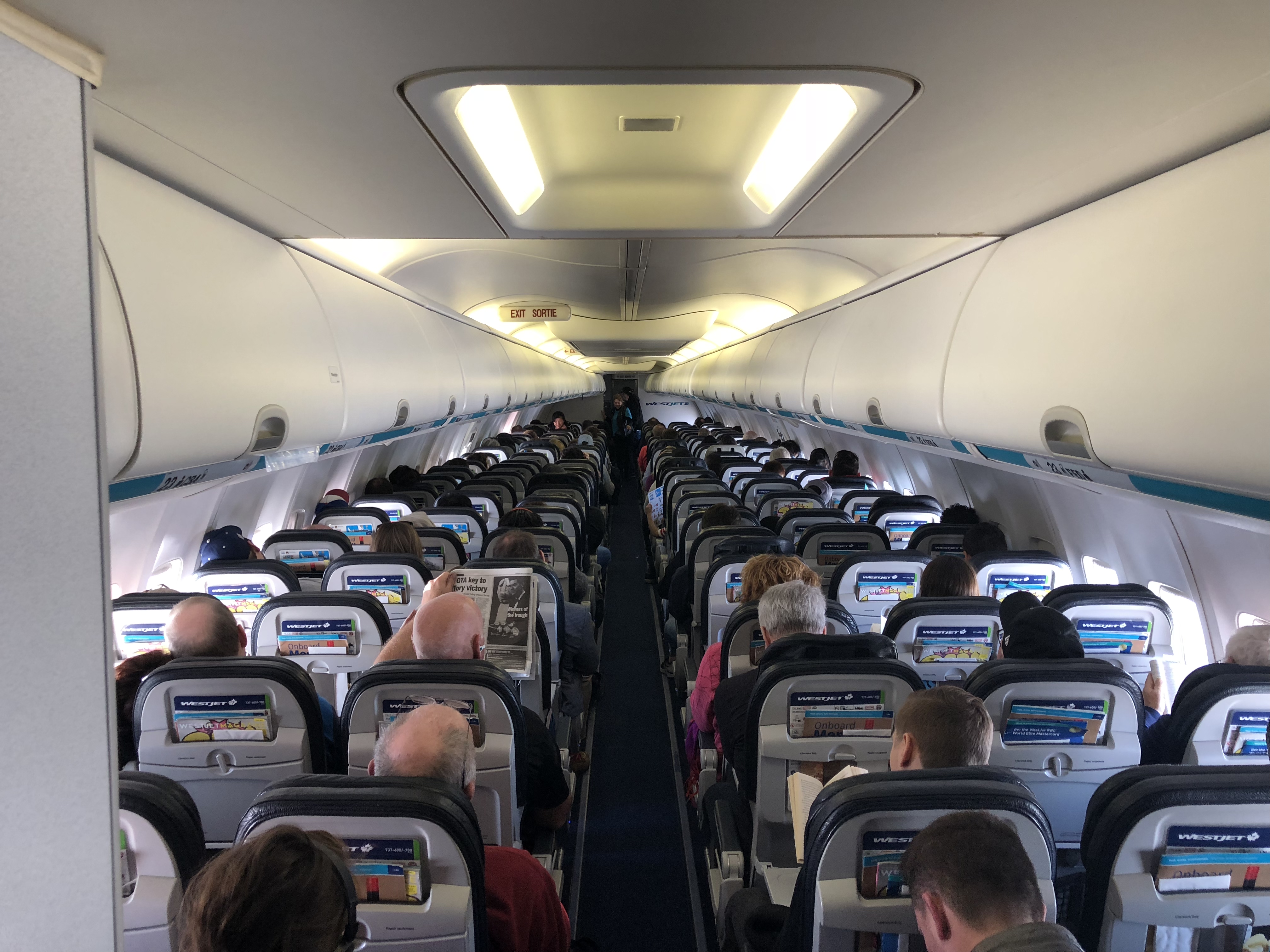 a group of people sitting in an airplane