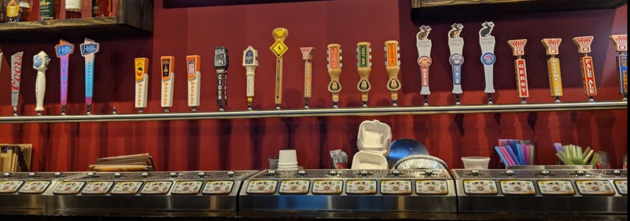 a row of beer taps on a bar