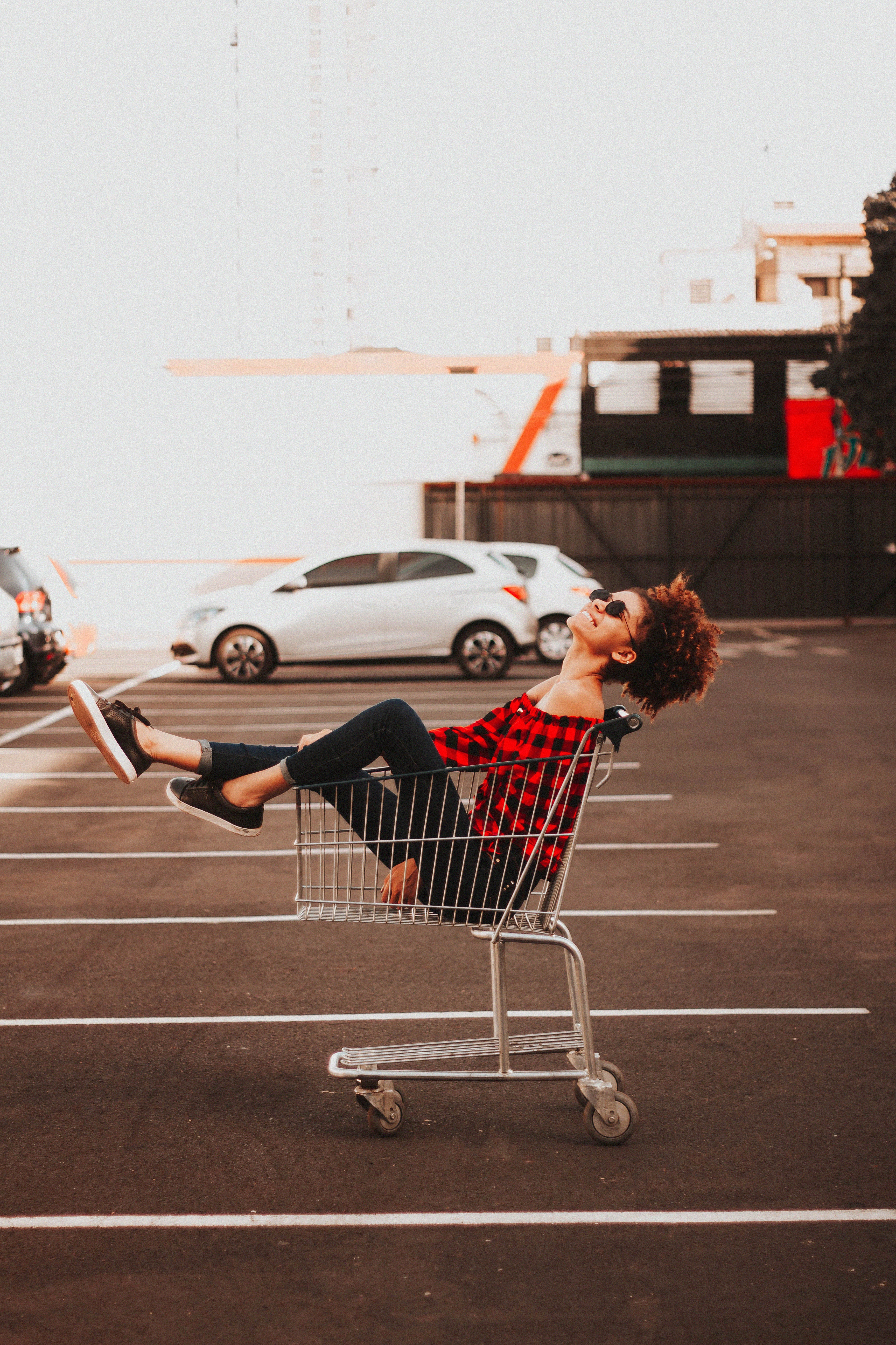 a woman sitting in a shopping cart