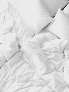 a white bedding with pillows