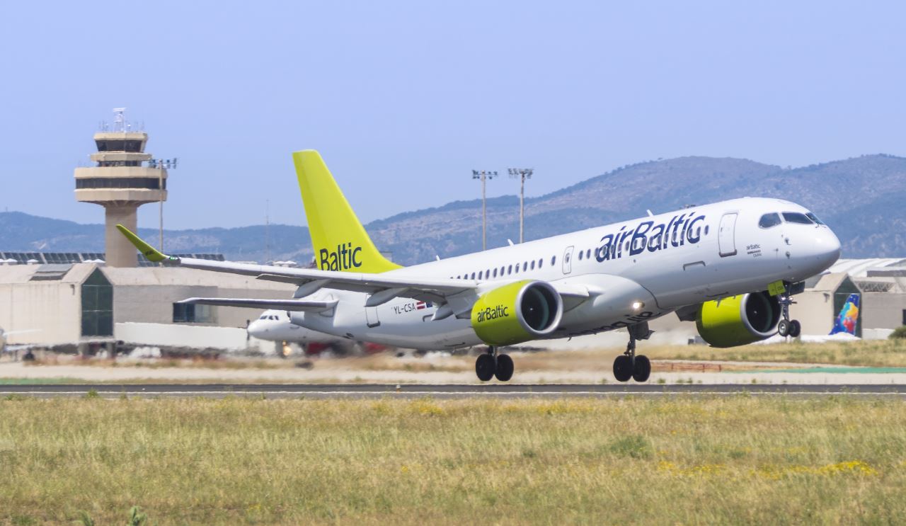 a white and yellow airplane on a runway