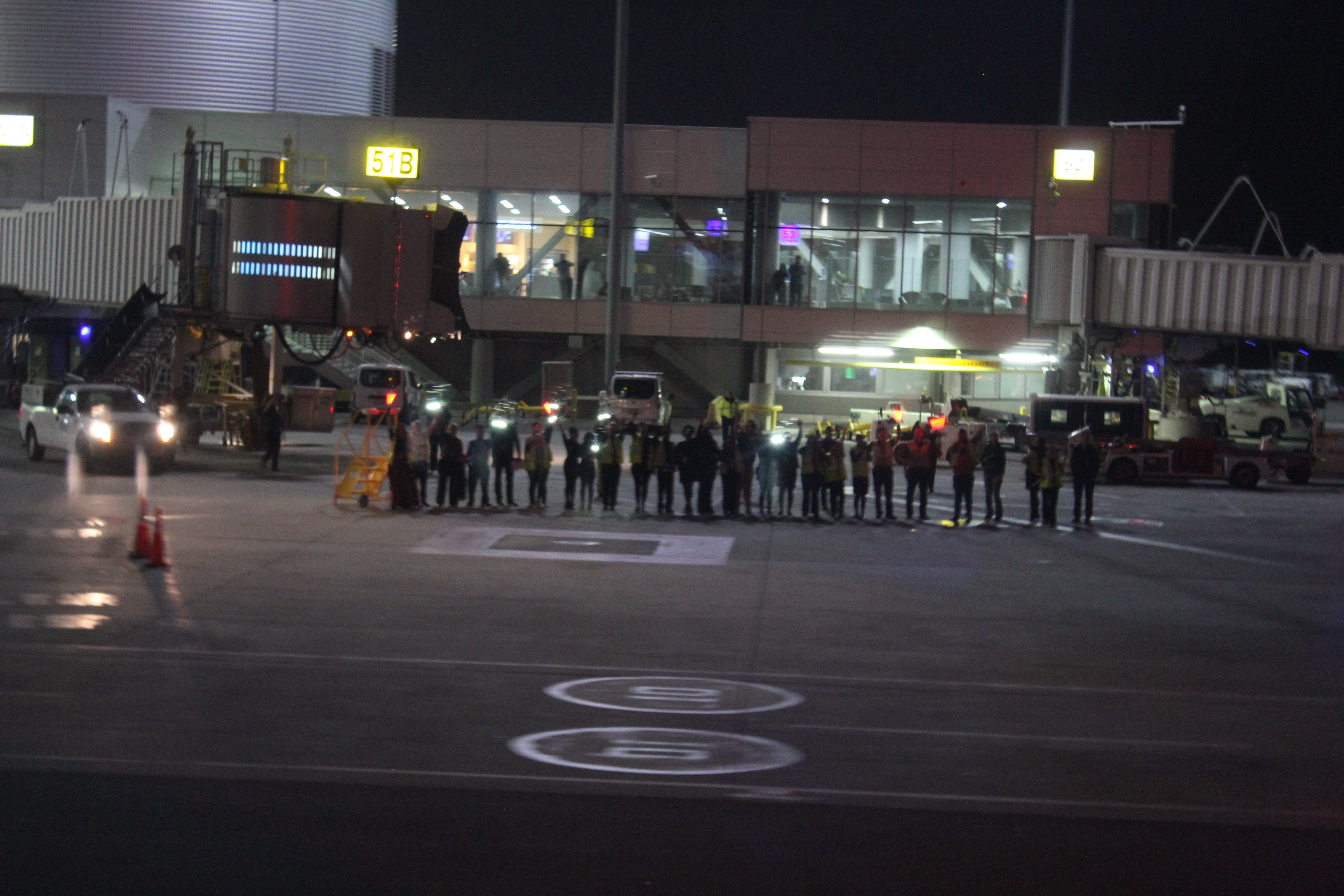 a group of people standing in a line in front of a building