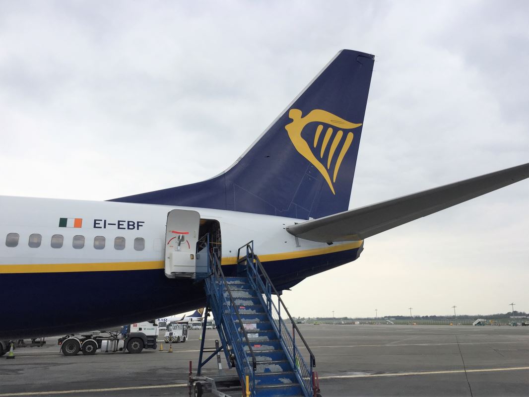 a blue and white airplane with a ladder