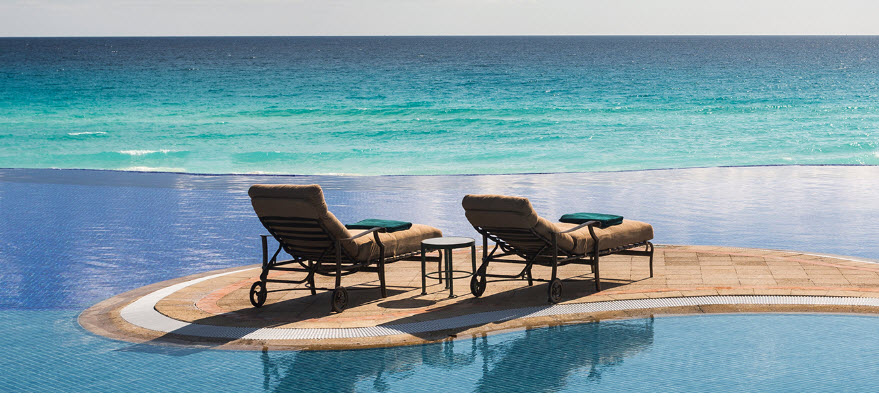 chairs next to a pool