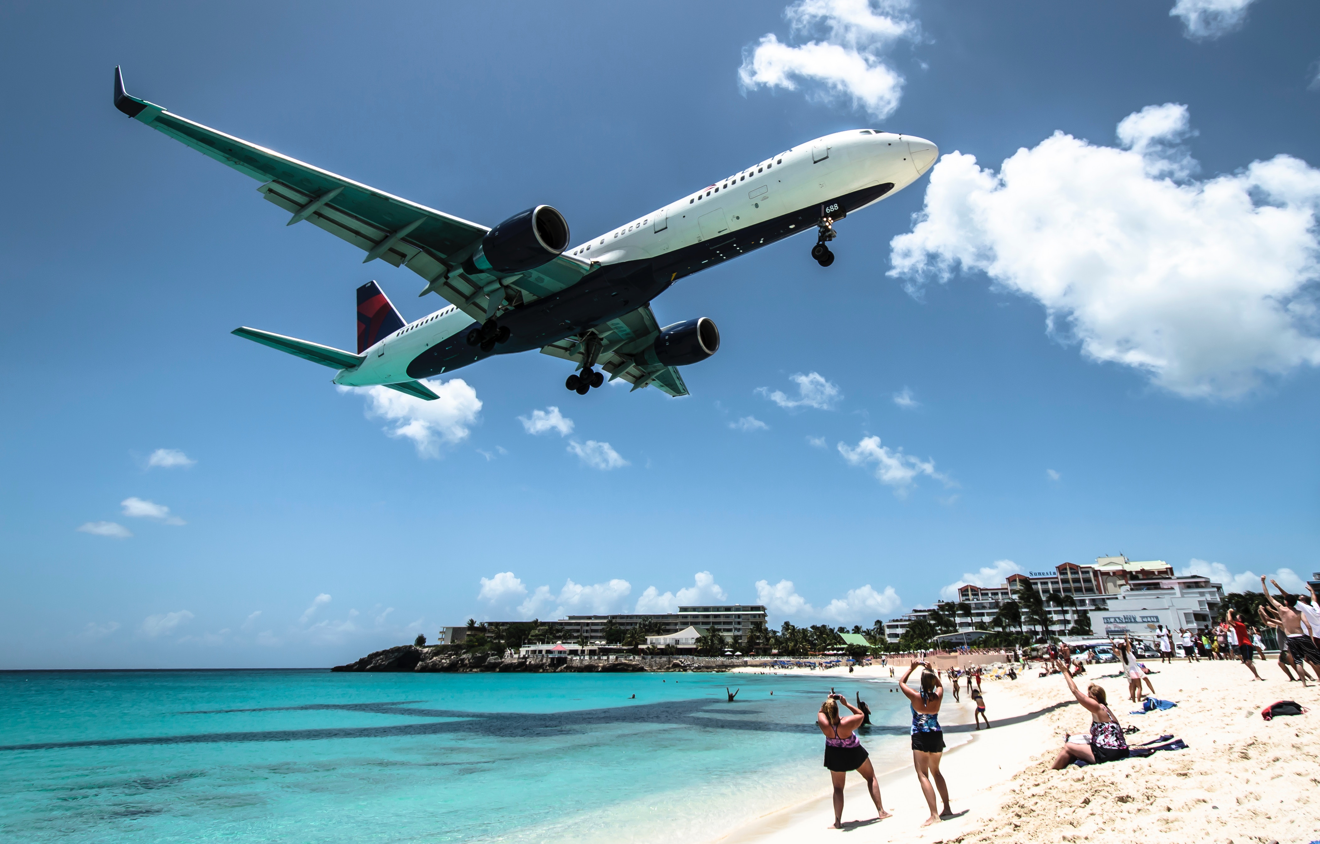 a plane flying over a beach