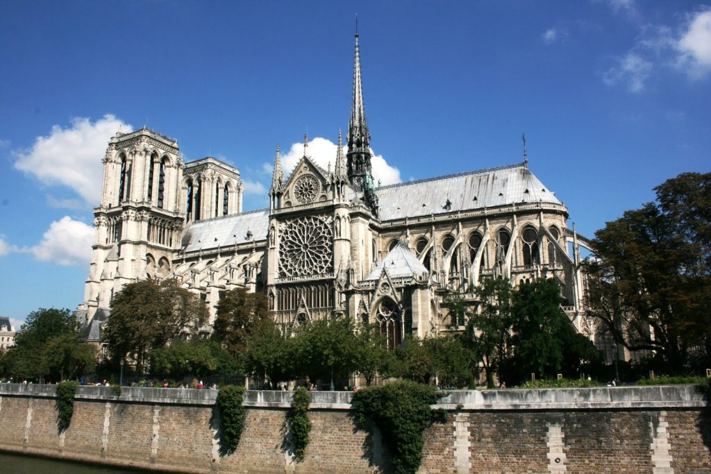 a large building with a spire with Notre Dame de Paris in the background
