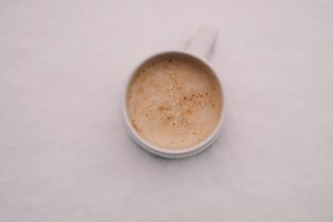 a cup of coffee on a white surface