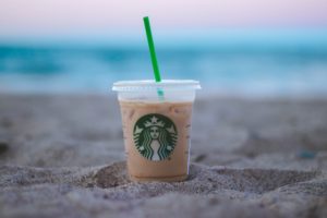 a cup of coffee on the sand
