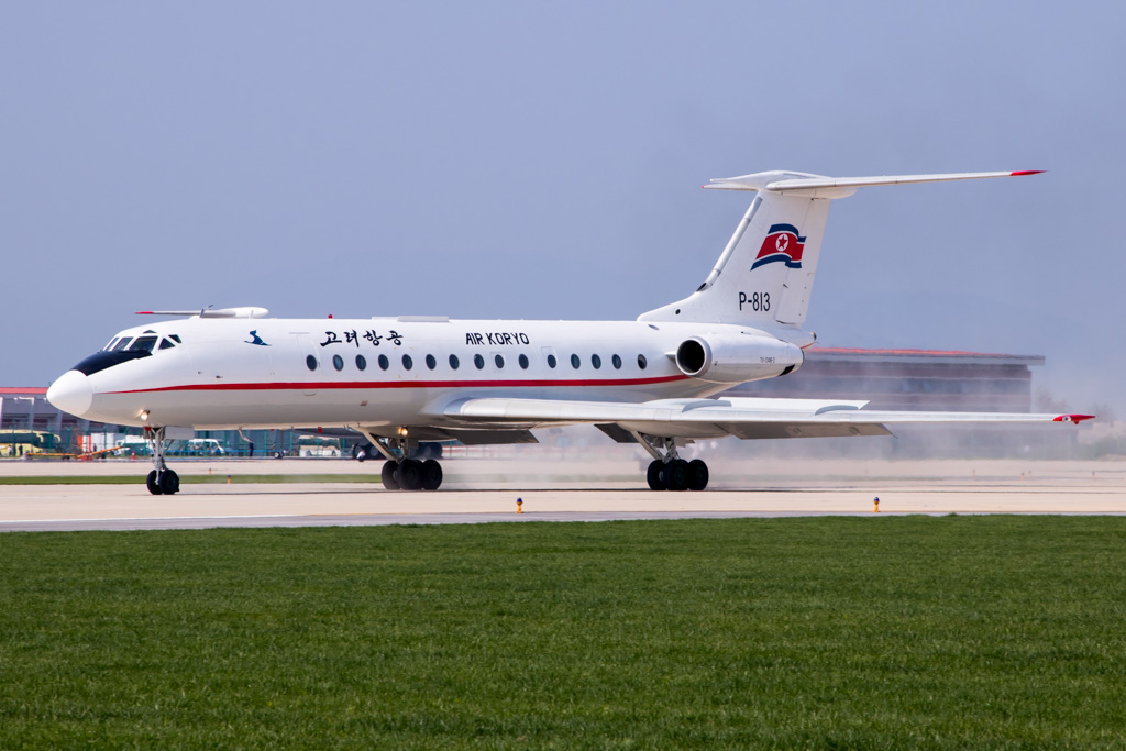 a white airplane on a runway