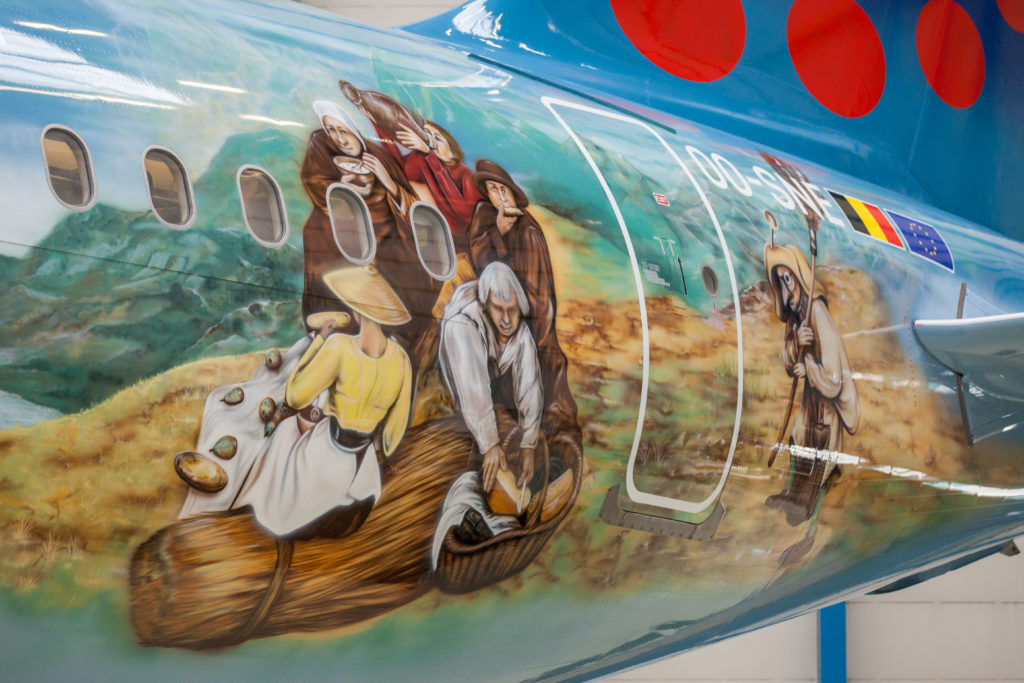 a painted airplane with people on it