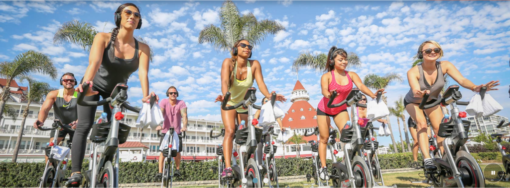 a group of people riding exercise bikes