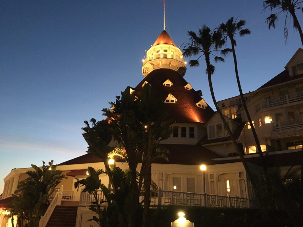 a building with a tower and palm trees