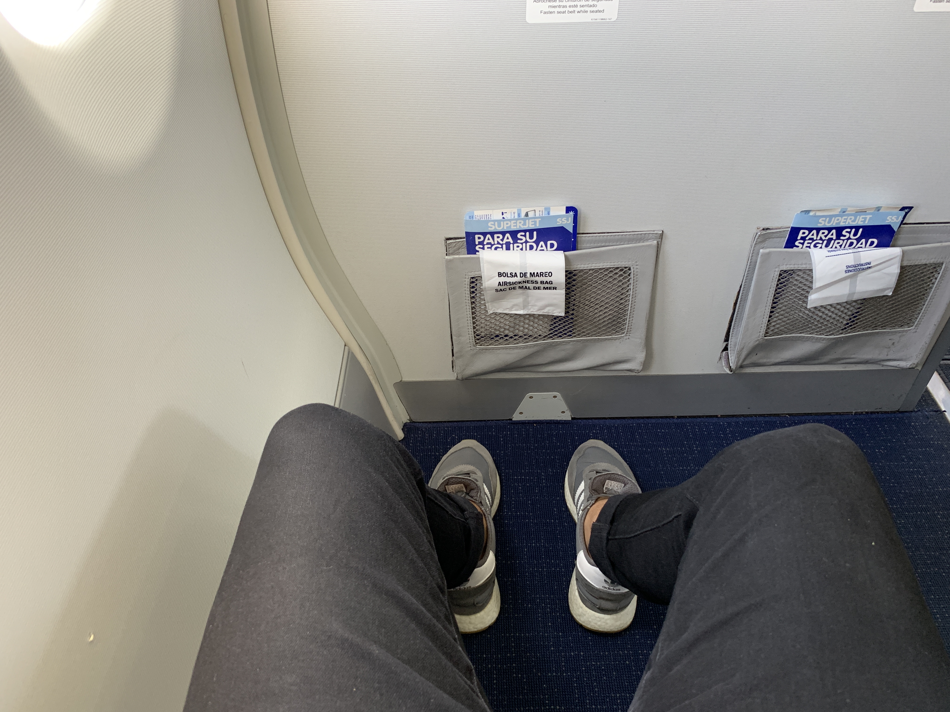 a person's legs and feet on a plane