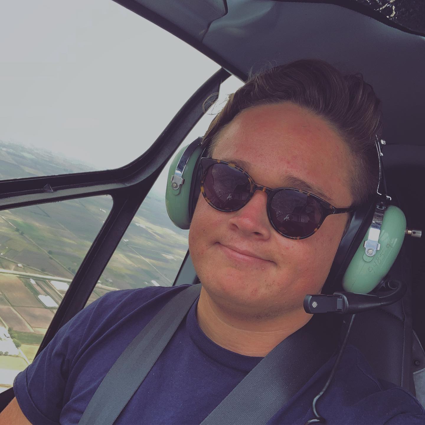 a man in sunglasses and headphones taking a selfie