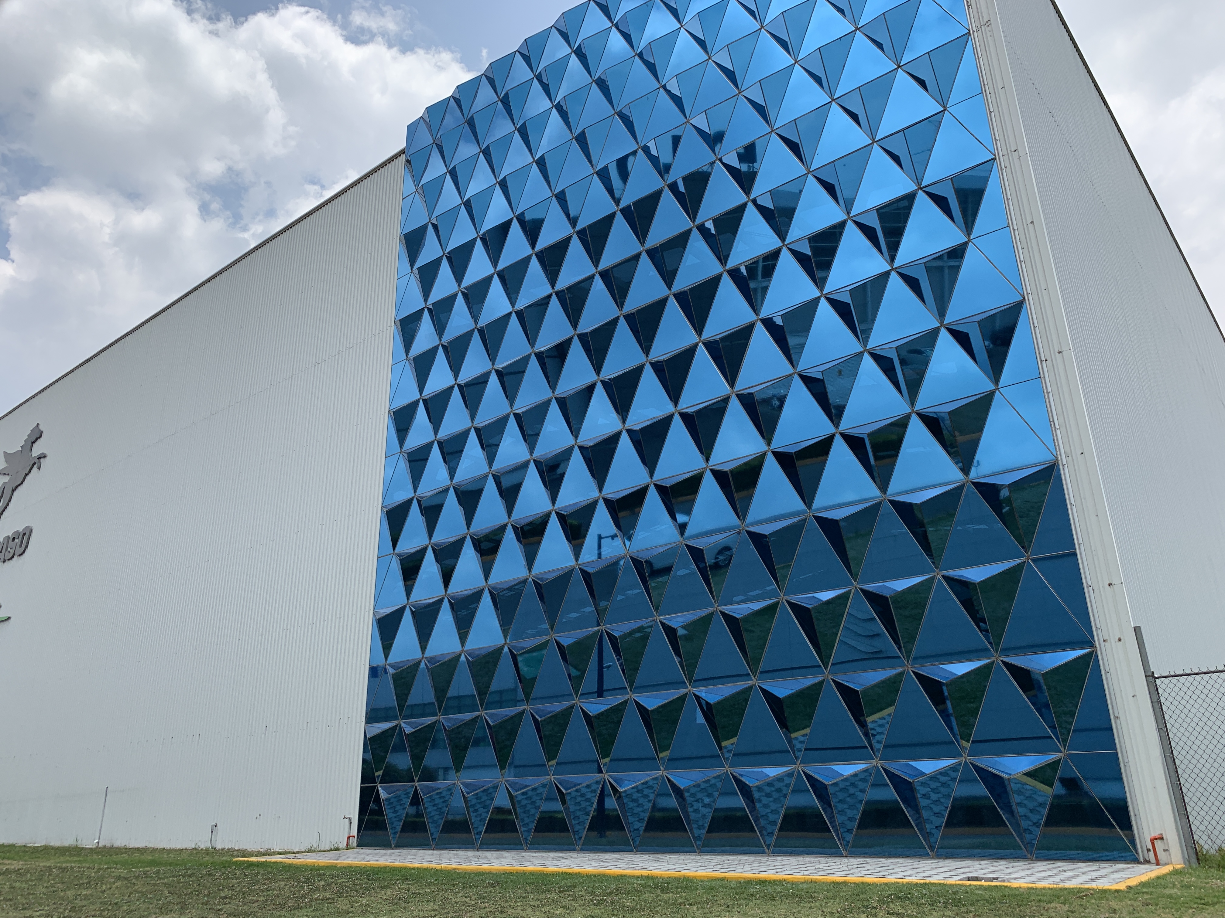 a building with blue triangles on the side