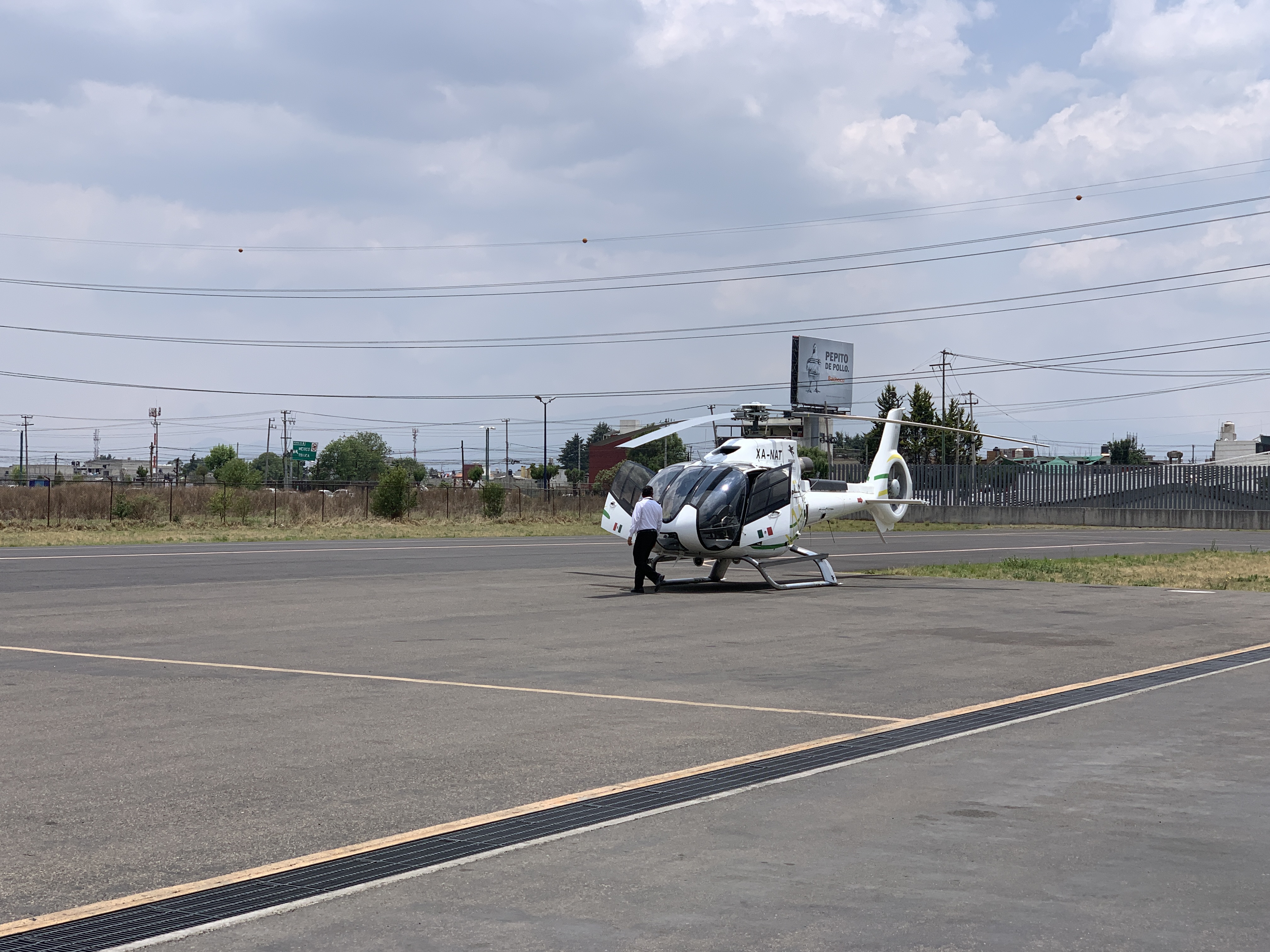 a helicopter on the ground with Vysoké Mýto Regional Museum in the background